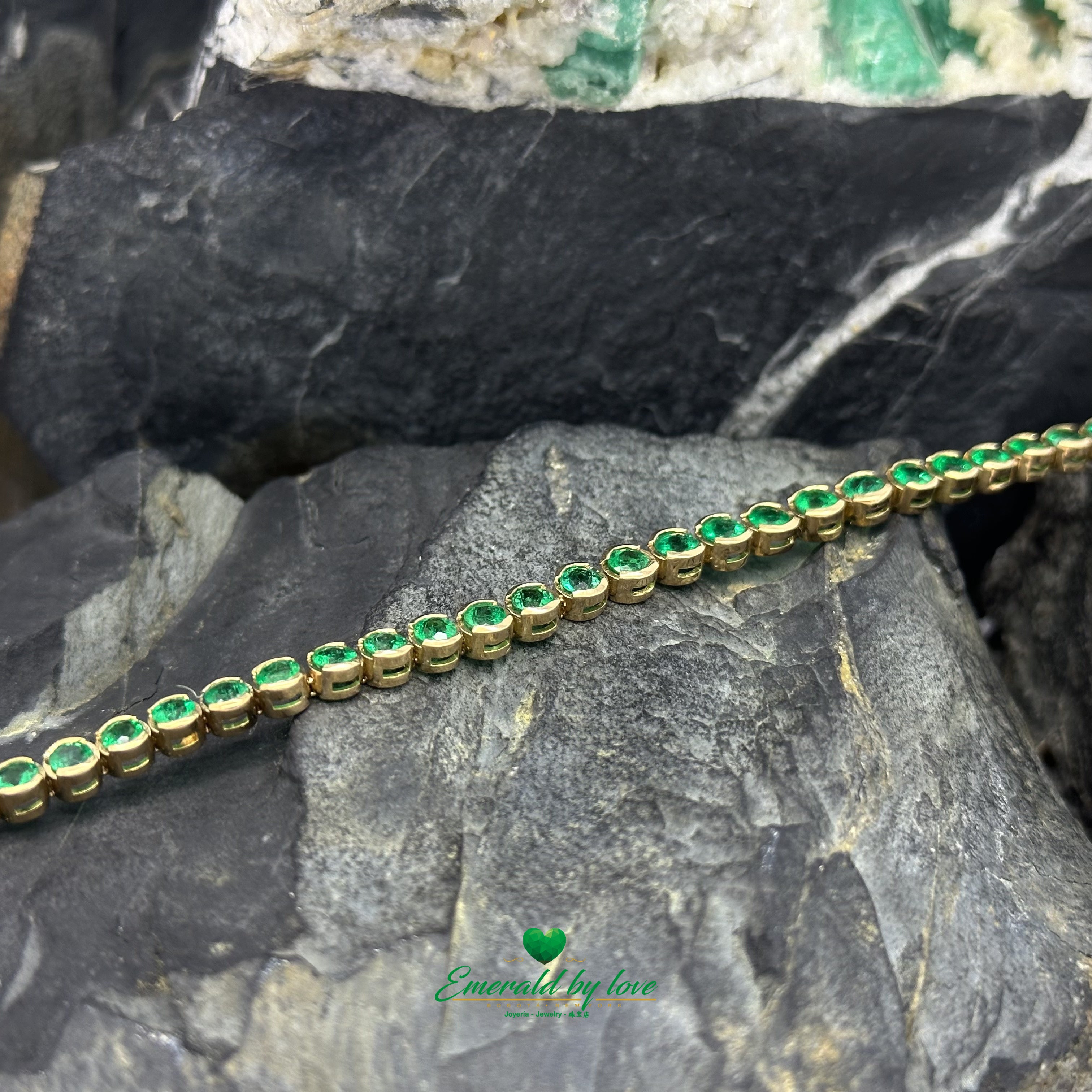 Elegant gold bracelet featuring round Colombian emeralds in bezel settings