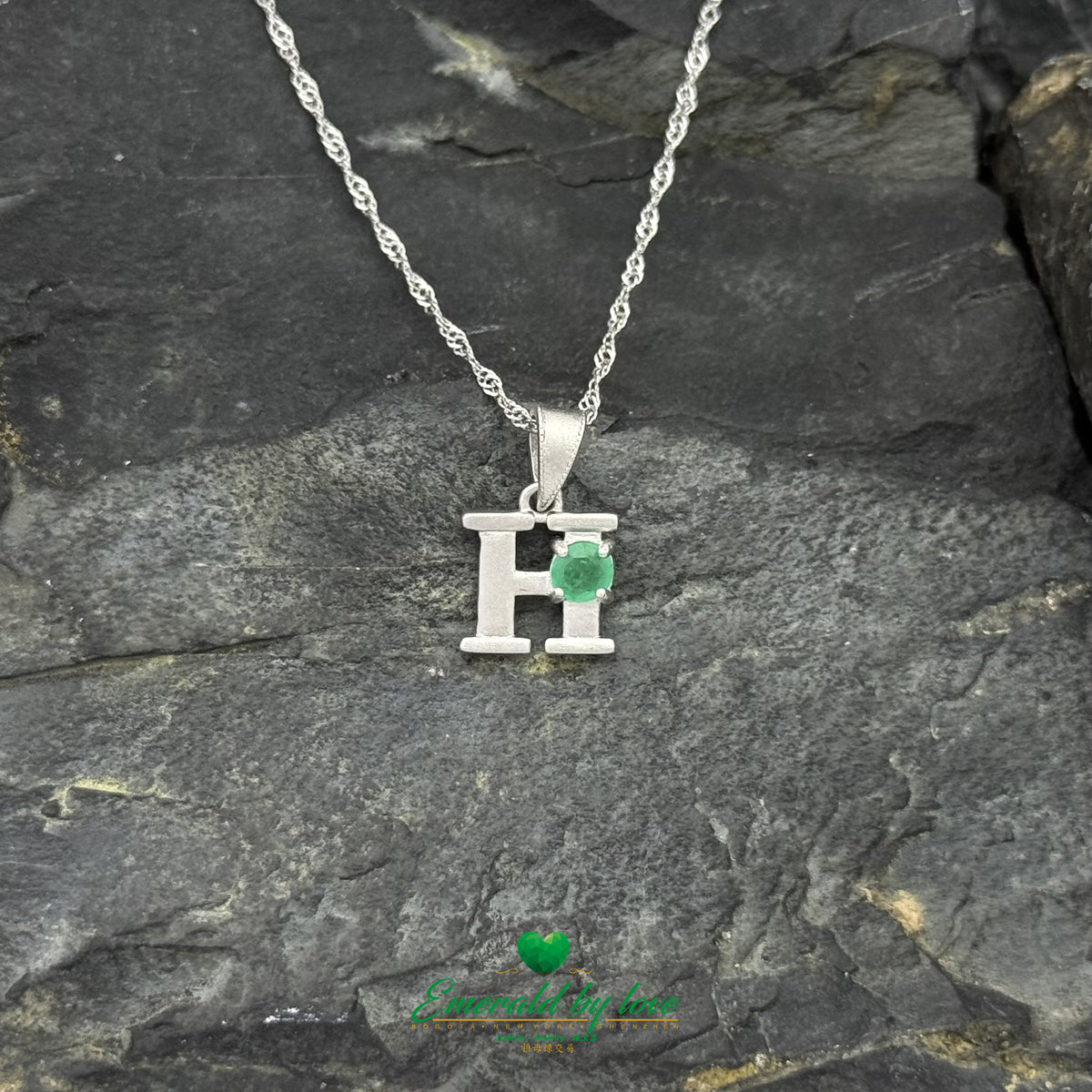 Sterling Silver H Pendant with a Central Green Emerald